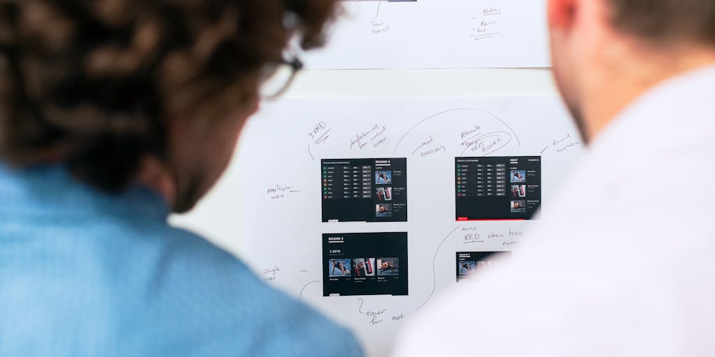 An artistic representation of a brainstorming session where a group of diverse individuals is gathered around a table, each using different AI writing tools on their laptops. The scene should capture the energy of collaboration, with colorful sticky notes and sketches scattered around, symbolizing creativity and innovation in writing.