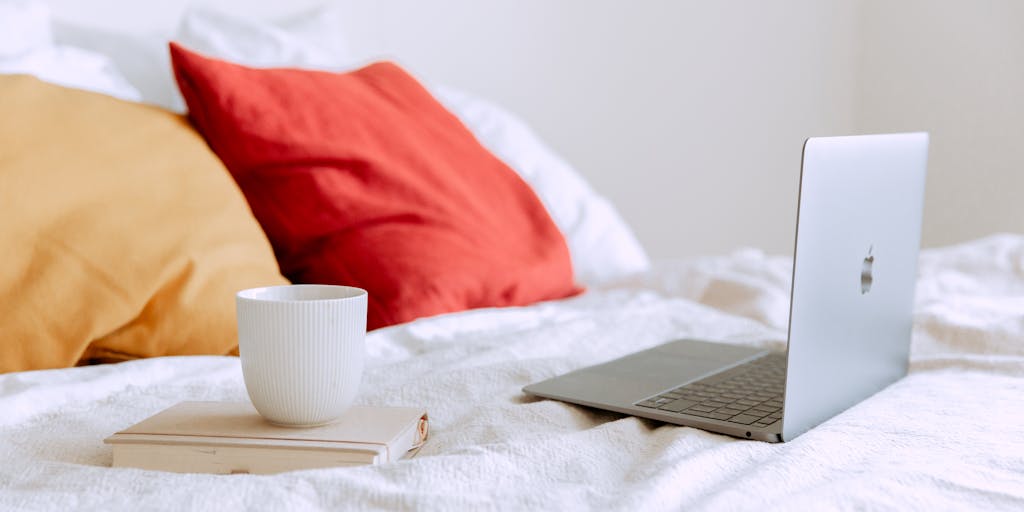 A vibrant workspace setup featuring a laptop displaying the Zoho Social dashboard, surrounded by colorful sticky notes and a coffee cup. The scene captures the essence of social media management, with a focus on productivity and creativity.