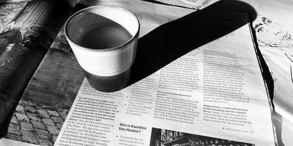 An overhead shot of two coffee cups on a table, one labeled 'Publer' and the other 'Metricool'. Surrounding the cups are various social media icons and analytics charts made from coffee art, symbolizing the brewing of social media strategies.