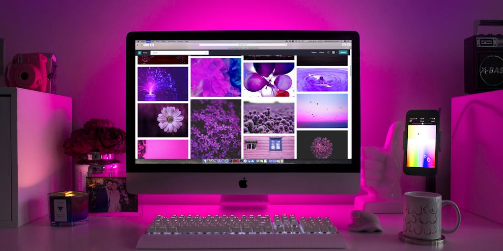 A split-screen image showcasing two different workspaces: on one side, a vibrant and colorful desk setup representing Zoho Social with its branding elements, and on the other side, a sleek, minimalist workspace symbolizing FeedHive. Each side should have a laptop open displaying their respective dashboards, with a coffee cup and notepad to add a personal touch.