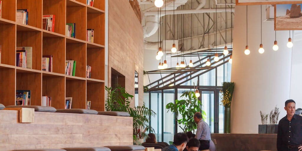 A split-screen image showcasing two distinct workspaces: on one side, a vibrant, collaborative environment representing FeedHive with colorful sticky notes, brainstorming sessions, and team members engaged in discussions. On the other side, a sleek, modern office setup for Vista Social, featuring high-tech gadgets, digital screens displaying analytics, and a focused individual working on social media strategies. The contrast highlights the different approaches to social media management.