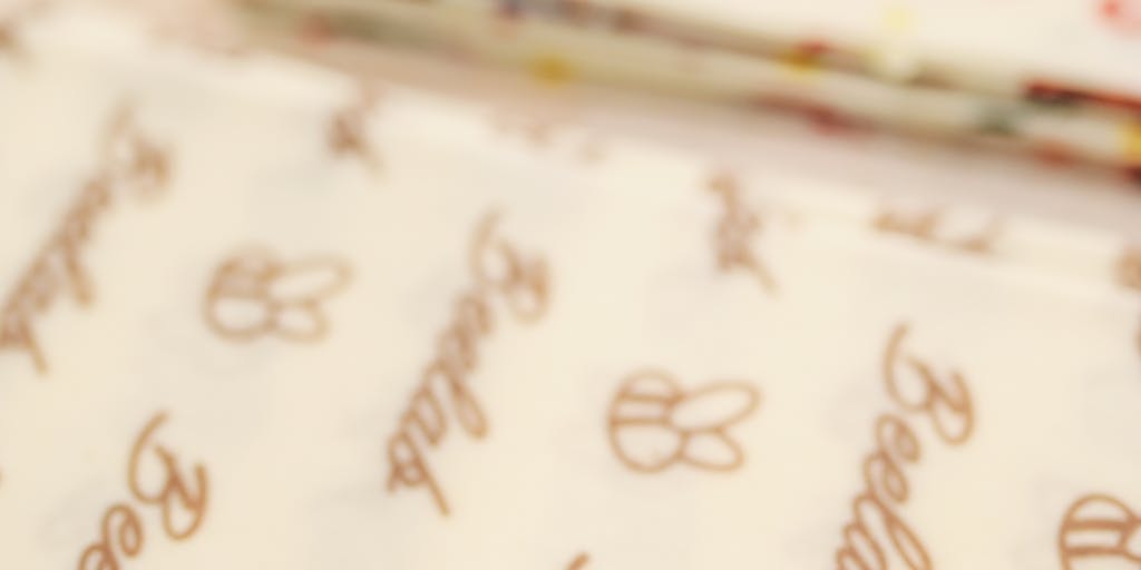 A whimsical illustration of a bee flying alongside a small airplane, with a backdrop of social media icons. The bee is carrying a briefcase labeled 'SocialBee' while the airplane has a banner trailing behind it that reads 'SocialPilot', showcasing the competition in a fun and engaging way.