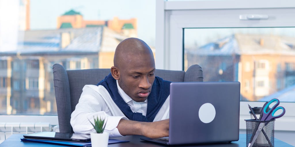 A dynamic action shot of two marketers in a friendly debate, one holding a Metricool logo and the other a Zoho Social logo. They are animatedly discussing their favorite features, with a whiteboard in the background showcasing pros and cons of each platform.